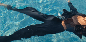 person in pool with clothes on