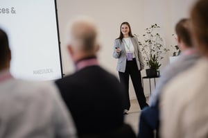 Woman presenting and smiling