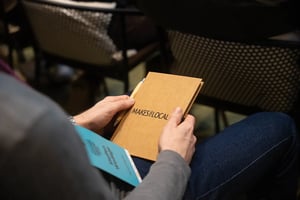 visitor holding a notebook