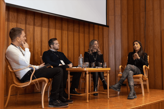 Speakers in a discussion on stage