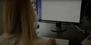Blonde woman working at a computer